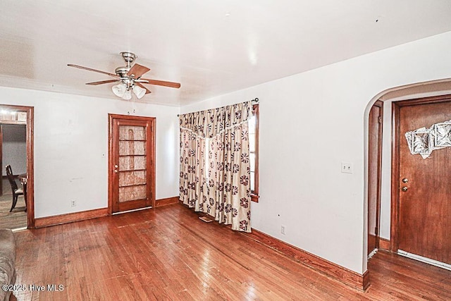 foyer with ceiling fan and wood-type flooring