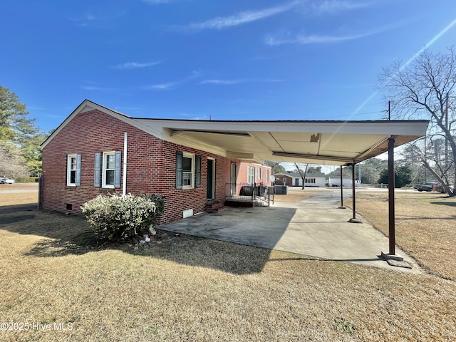 view of side of home with a lawn and a carport