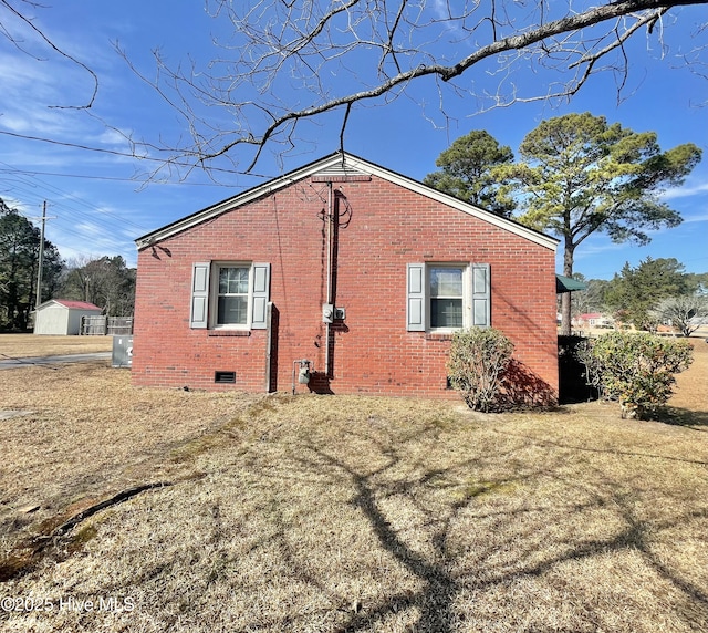 view of side of property with a lawn