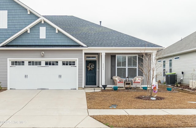 view of front of property featuring central AC and a garage