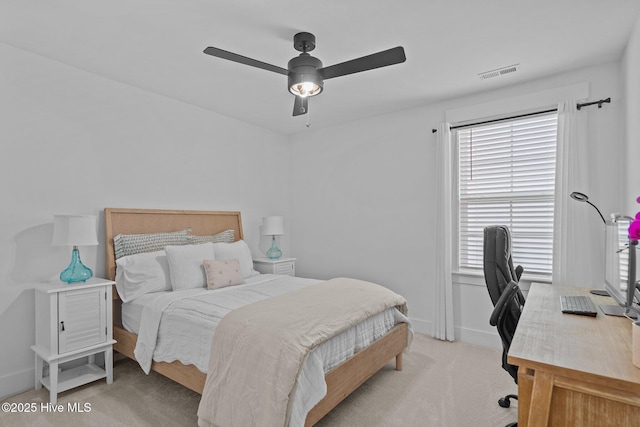 bedroom with ceiling fan and light carpet