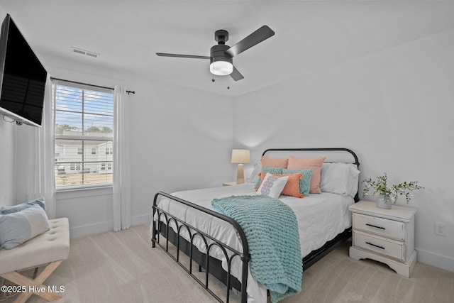 bedroom featuring light colored carpet and ceiling fan