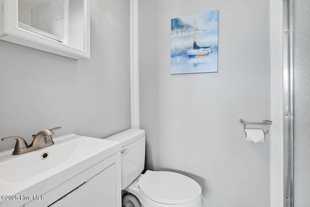 bathroom with toilet and vanity