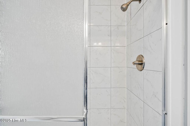 bathroom with tiled shower