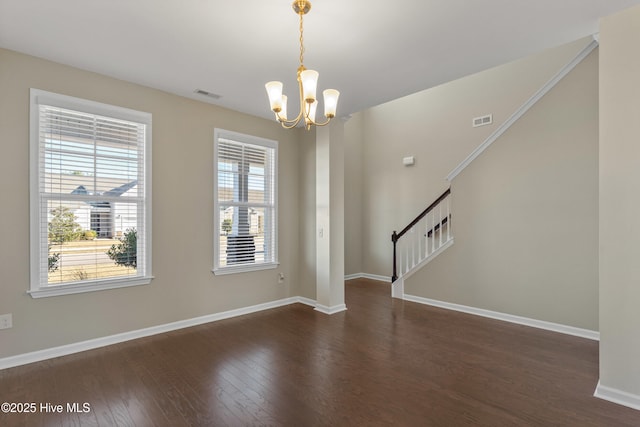 unfurnished room with dark wood-type flooring, stairway, visible vents, and an inviting chandelier