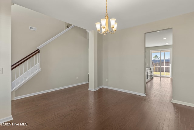 unfurnished dining area featuring dark wood-style flooring, visible vents, an inviting chandelier, baseboards, and stairs