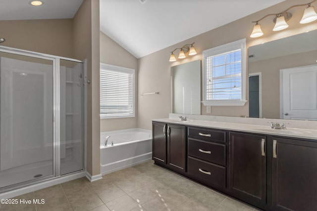 full bath featuring a stall shower, a garden tub, and a sink