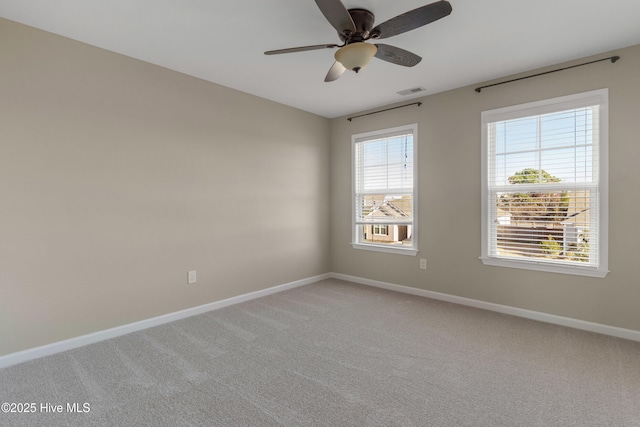 unfurnished room with plenty of natural light, visible vents, and baseboards