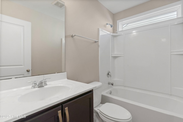 full bathroom featuring shower / bath combination, visible vents, vanity, and toilet