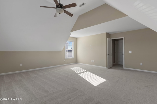 bonus room featuring visible vents, a ceiling fan, light carpet, vaulted ceiling, and baseboards