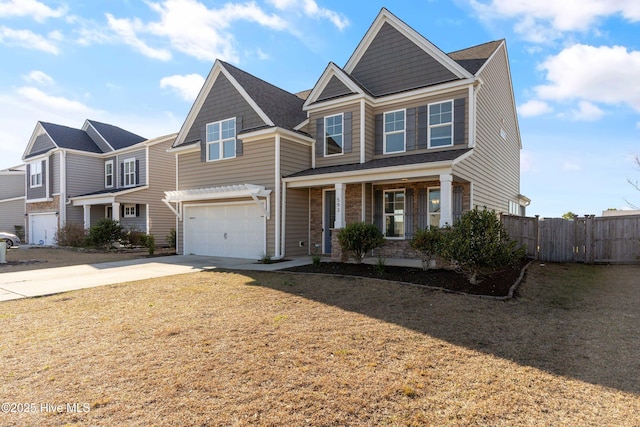 view of front of house featuring a garage, concrete driveway, a front lawn, and fence