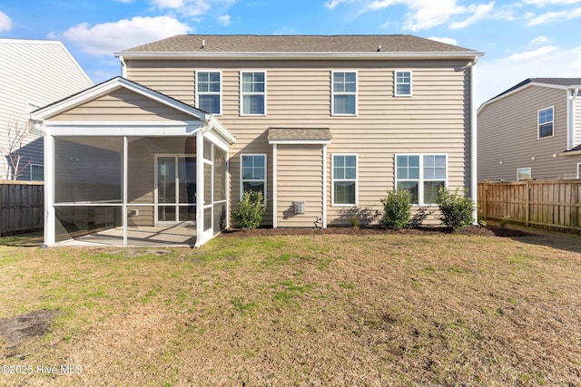 back of house with fence private yard, a sunroom, a patio area, and a yard