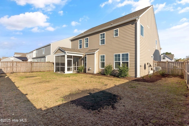 rear view of house with a yard, cooling unit, a fenced backyard, and a sunroom