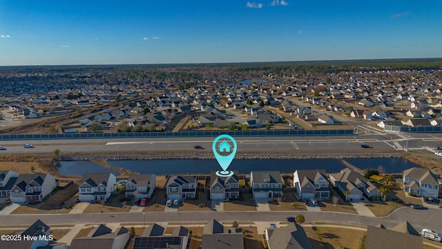 drone / aerial view with a residential view and a water view