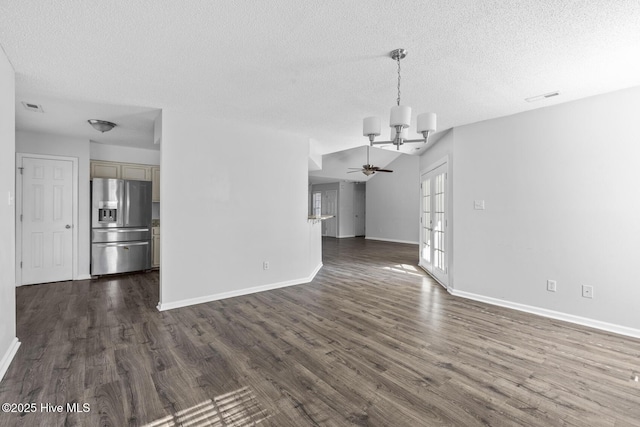 unfurnished living room featuring dark hardwood / wood-style flooring, french doors, a textured ceiling, and ceiling fan with notable chandelier