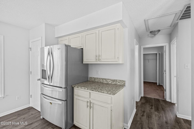 kitchen featuring white cabinets, dark hardwood / wood-style floors, and stainless steel fridge