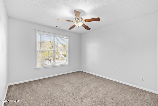 carpeted empty room featuring a textured ceiling and ceiling fan