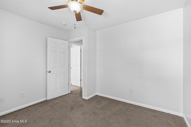 unfurnished room featuring dark carpet and ceiling fan