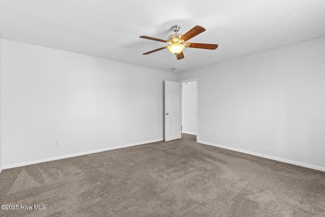 carpeted spare room with ceiling fan and a textured ceiling