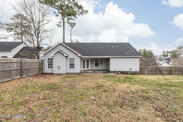 rear view of property featuring a patio and a lawn