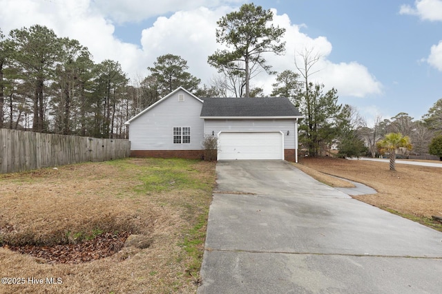 view of side of property featuring a garage and a lawn