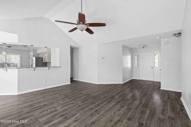 unfurnished living room with lofted ceiling, ceiling fan, and dark hardwood / wood-style floors