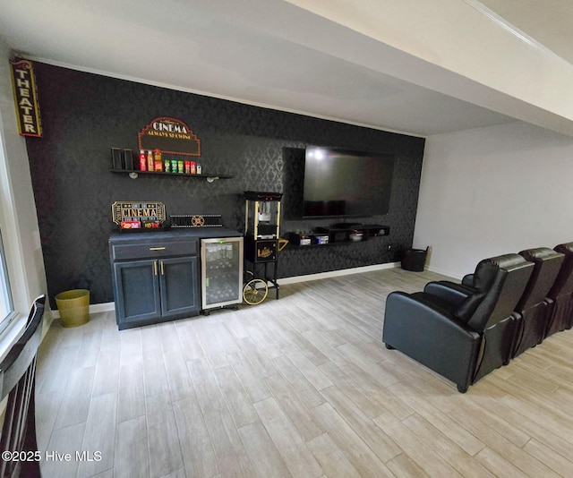 bar featuring beverage cooler and light hardwood / wood-style flooring