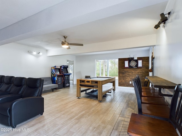 living room with light hardwood / wood-style flooring and ceiling fan