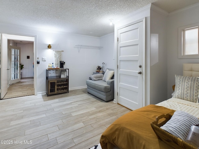 bedroom with ornamental molding and a textured ceiling