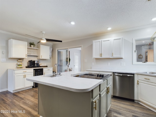 kitchen featuring dishwasher, sink, white cabinets, a kitchen island with sink, and black electric stovetop