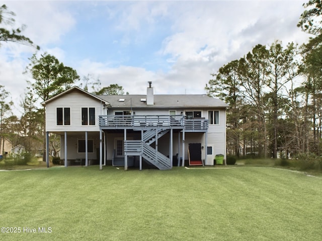 rear view of property with a yard and a deck