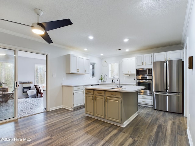 kitchen featuring stainless steel appliances, a kitchen island, sink, and white cabinets