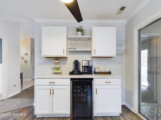 bar featuring white cabinets, wood-type flooring, and wine cooler