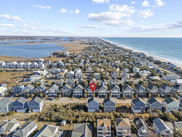 birds eye view of property featuring a water view and a view of the beach