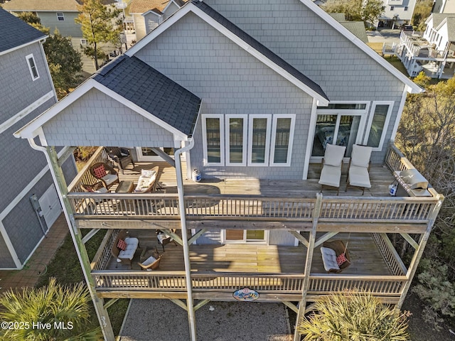 rear view of property featuring a wooden deck