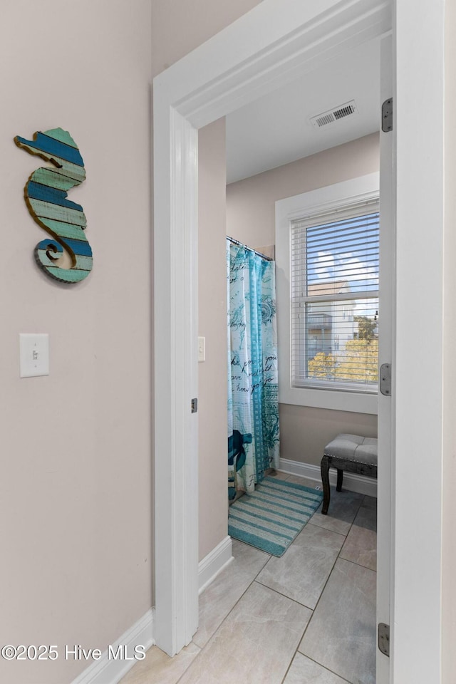 bathroom with tile patterned floors