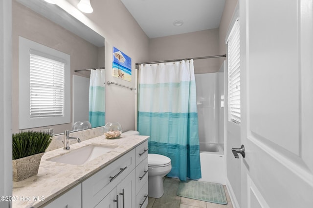 full bathroom with shower / tub combo, plenty of natural light, vanity, tile patterned floors, and toilet