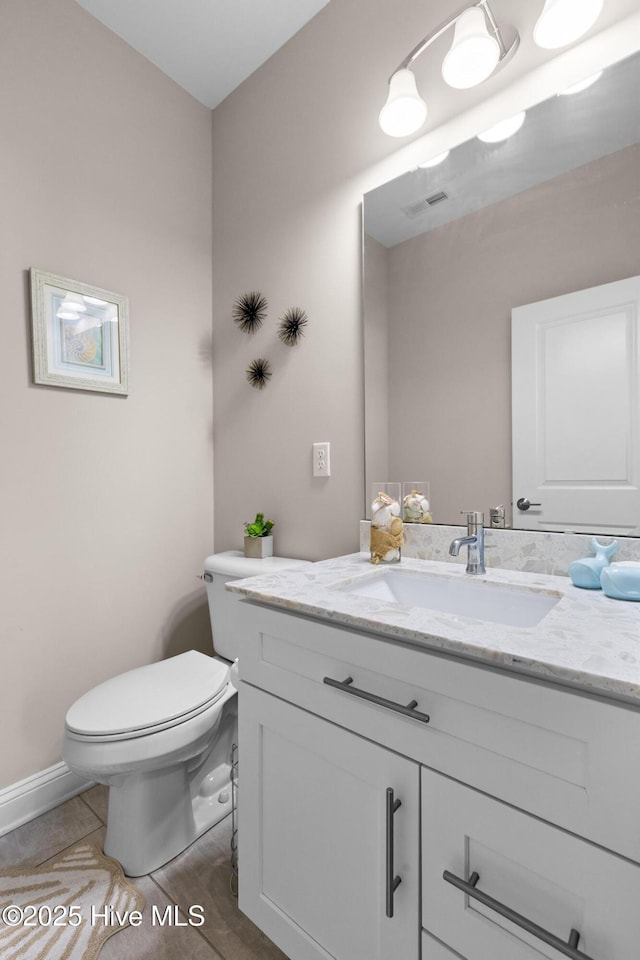 bathroom with vanity, tile patterned floors, and toilet