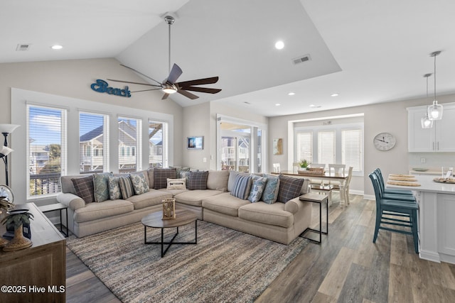 living room with vaulted ceiling, ceiling fan, and light hardwood / wood-style floors