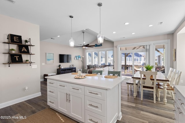 kitchen featuring white cabinetry, plenty of natural light, wood-type flooring, and pendant lighting