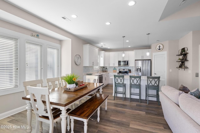 dining space featuring dark hardwood / wood-style flooring