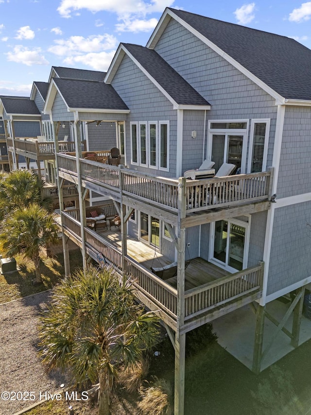 rear view of property featuring a balcony