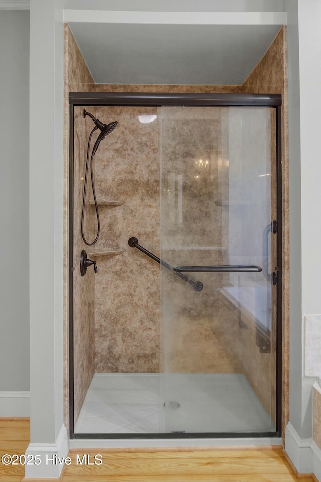 bathroom featuring hardwood / wood-style floors and a shower with door