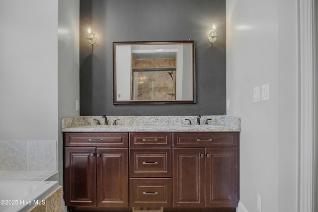 bathroom with vanity and shower with separate bathtub