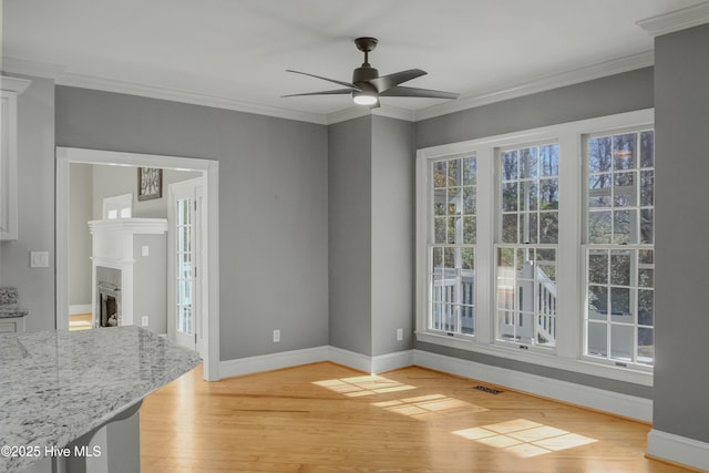 dining area featuring crown molding, ceiling fan, and light wood-type flooring