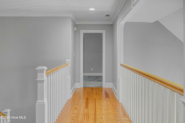 hall featuring crown molding and light wood-type flooring