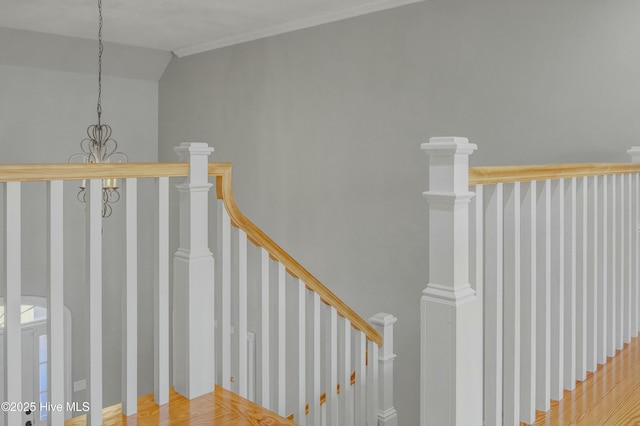 stairway featuring lofted ceiling and hardwood / wood-style flooring