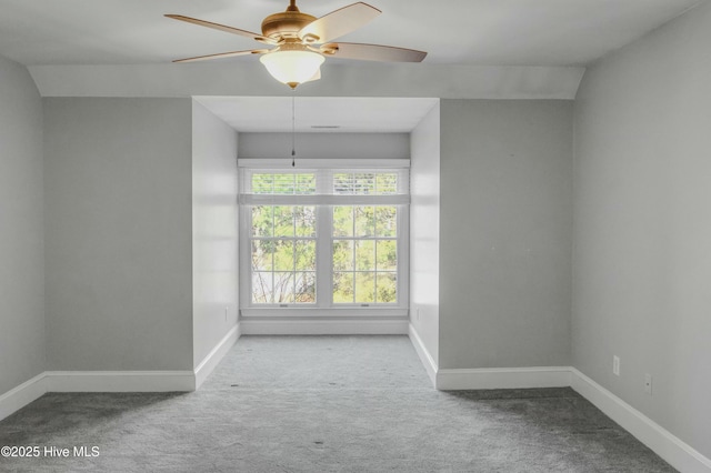 carpeted spare room featuring ceiling fan