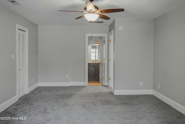 empty room with ceiling fan, sink, and light carpet