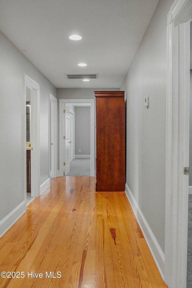 hall with light hardwood / wood-style floors